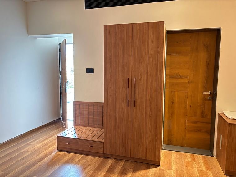 Entry wardrobe beside the suite door, with a low storage bench - Nath Hills - Villa Suite Interiors by Bosk Furniture